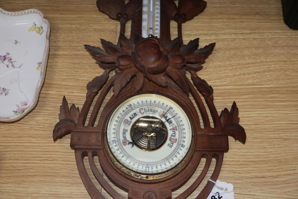 A Black Forest carved wall barometer, height 62cm